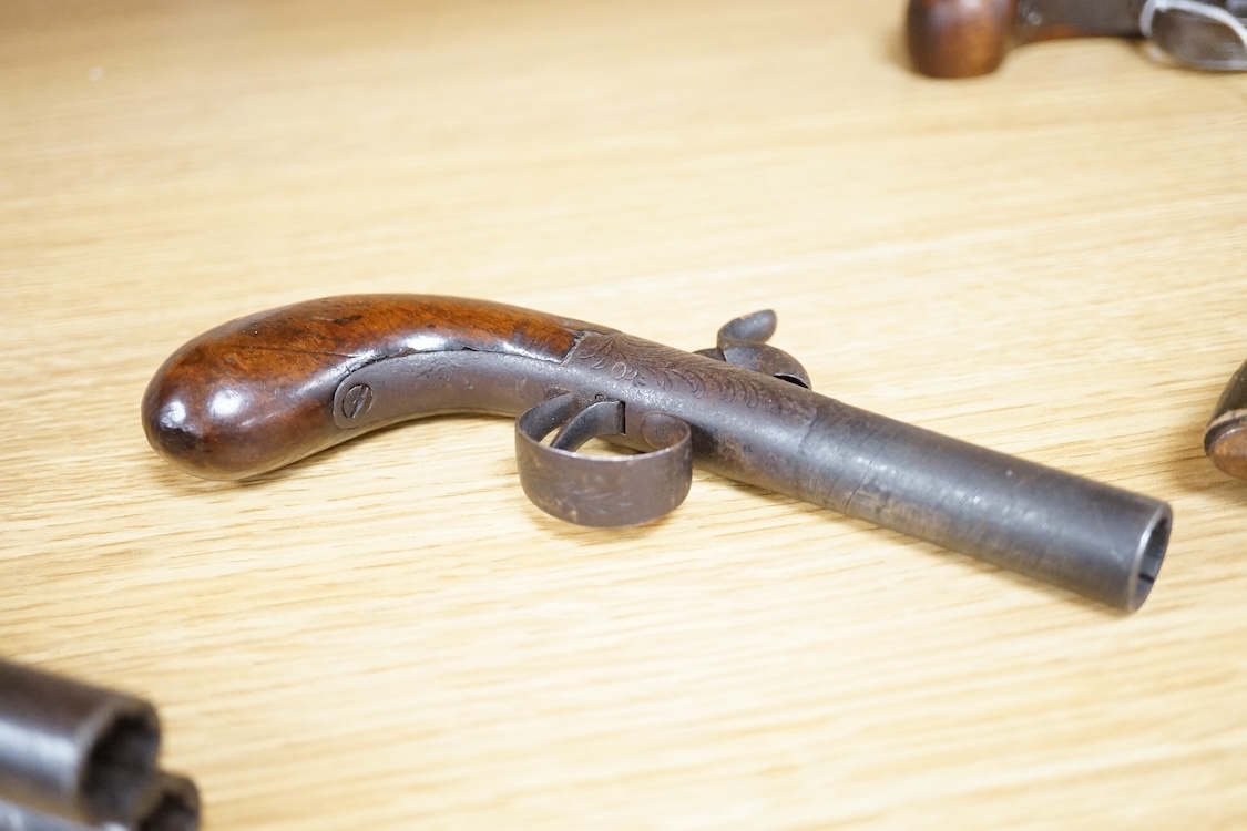 A boxlock percussion pocket pistol with turn off barrel etched with ribbon twist, engraved rounded frame, liege proved, with rounded walnut butt